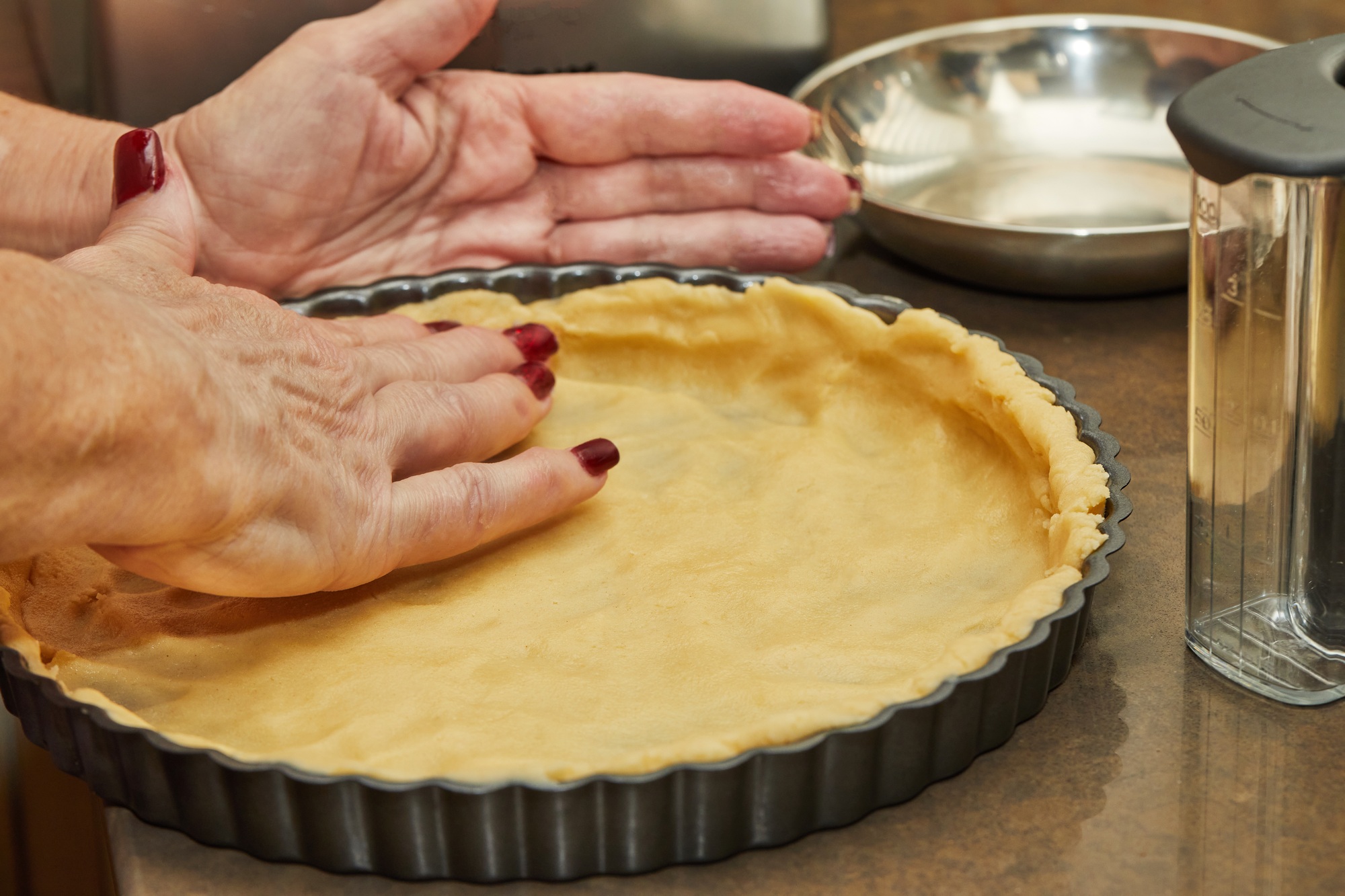Chef prepares pie and puts the dough into mold