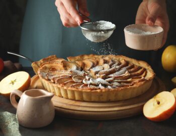 Concept of cooking apple pie on dark background