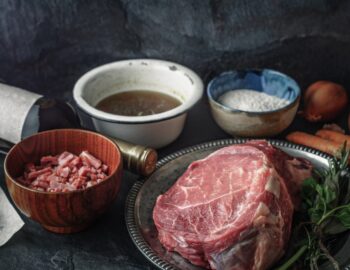Ingredients for Boeuf Bourguignon on the dark stone table horizontal