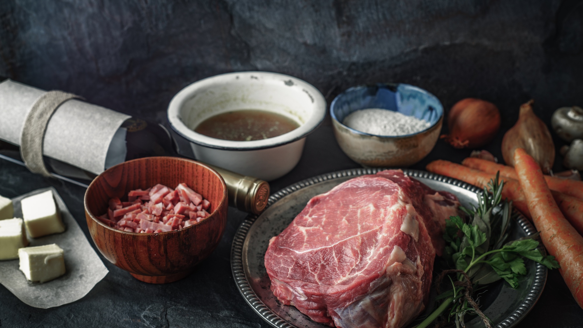Ingredients for Boeuf Bourguignon on the dark stone table horizontal