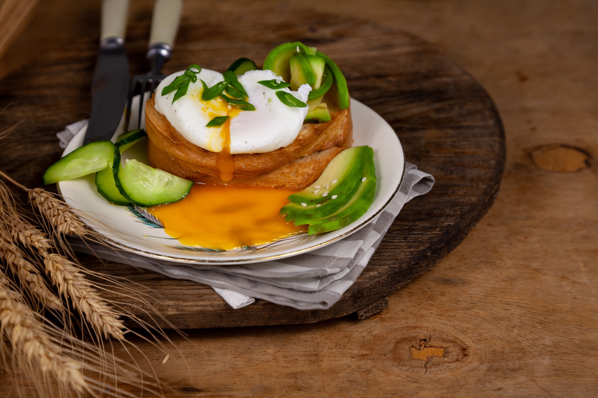 Poached egg for breakfast. Fried bread and avocado. The yolk comes from the protein. Appetizing food