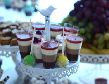 Pudding in layers with cocoa, strawberries, whipped cream, cappuccino and fruit combined with fondan