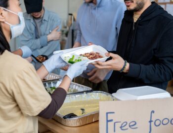 Volunteers serving free food to refugees or homeless people